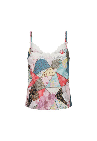 A woman wearing a patchwork print camisole dress with lace trim
