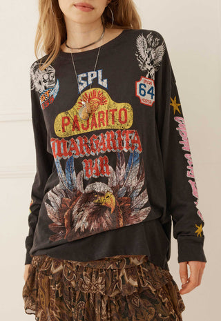A woman wearing a black long-sleeve graphic sweatshirt with a large 'Pajarito Margarita Bar' design on the front, featuring an eagle, Route 66 style shield, and other western-themed graphics.