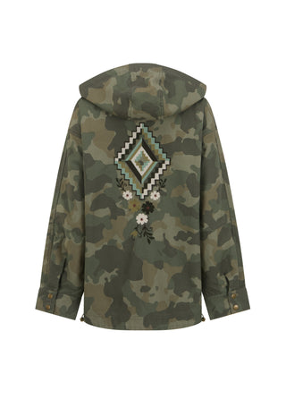 Close-up of a camouflage military-style jacket with a red and yellow bird patch on the sleeve and a red rectangular patch with '1976' on the chest pocket.